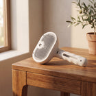 FELVO Vapor, Rechargeable Steam Grooming Brush styled in a warm modern interior